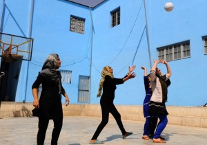 Women playing volleyball inside an Afghan prison for women in Herat. The prison was built in cooperation with an Italian NGO and offers skills training to prepare women for a life outside prison. Image by Aref Karimi/AFP/Getty Images